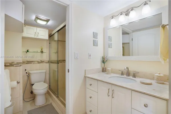 a bathroom with a granite countertop toilet sink and a mirror