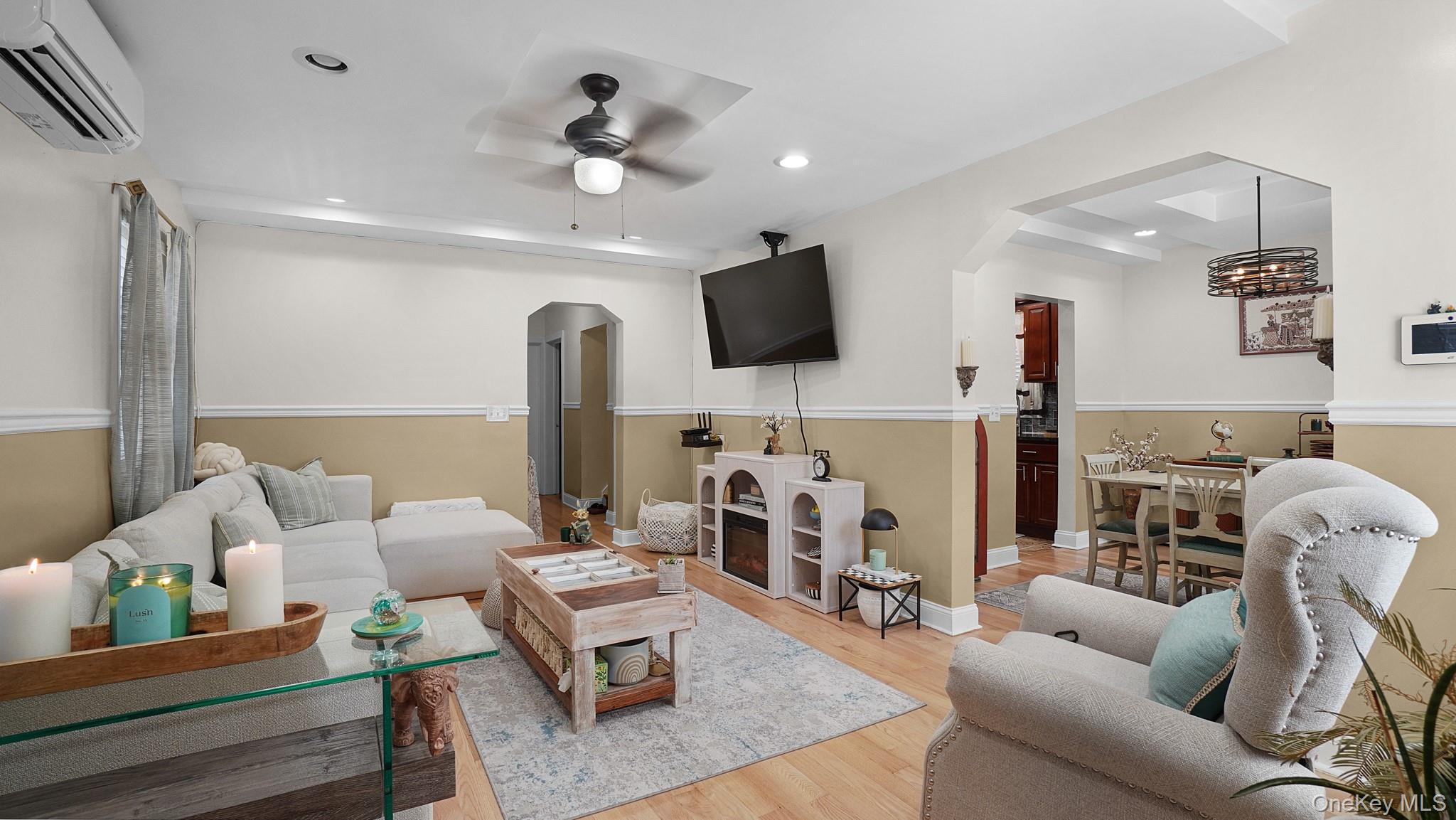 172-17 Amelia Road Queens, NY 11434 - Photo 3 of 18 a living room with furniture a flat screen tv and a fireplace