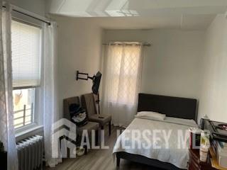 78 Center Street, Unit 2 Perth Amboy, NJ 08861 - Photo 6 of 8 a bedroom with a bed and a window