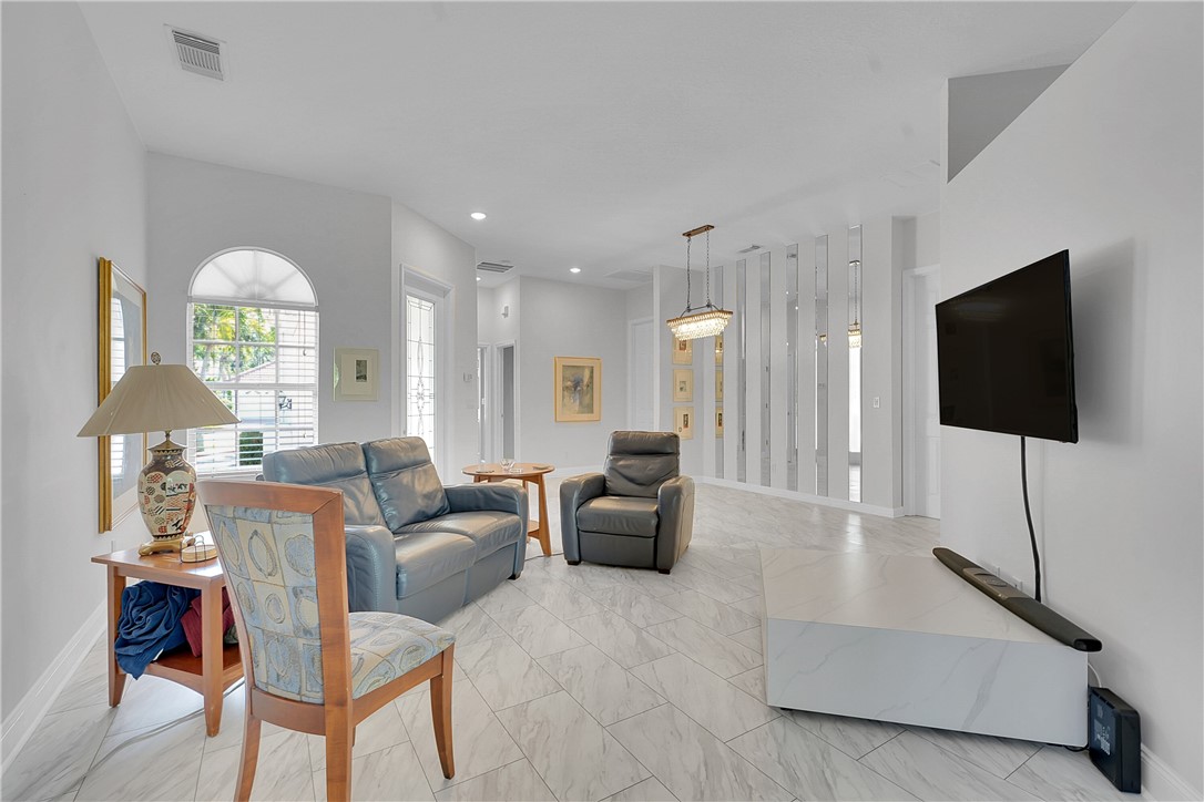 715 Southwest Munjack Circle Port St. Lucie, FL 34986 - Photo 11 of 36 a living room with furniture and a flat screen tv