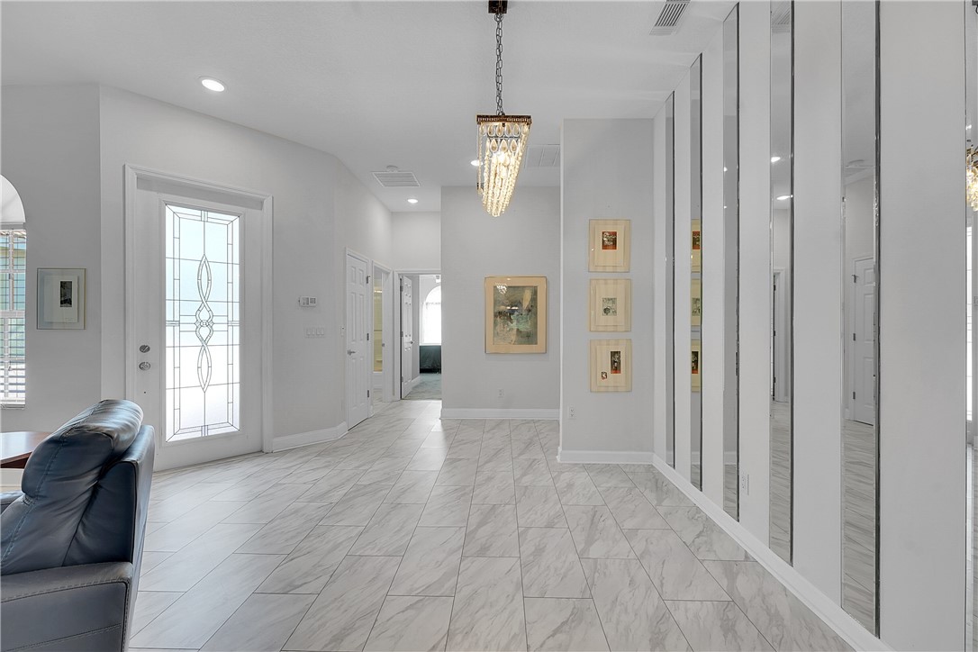 715 Southwest Munjack Circle Port St. Lucie, FL 34986 - Photo 12 of 36 a view of a hallway with wooden floor and cabinet