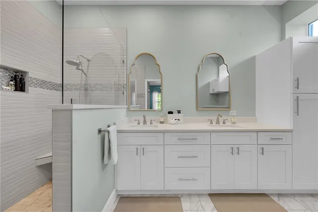 a spacious bathroom with a toilet sink and mirror