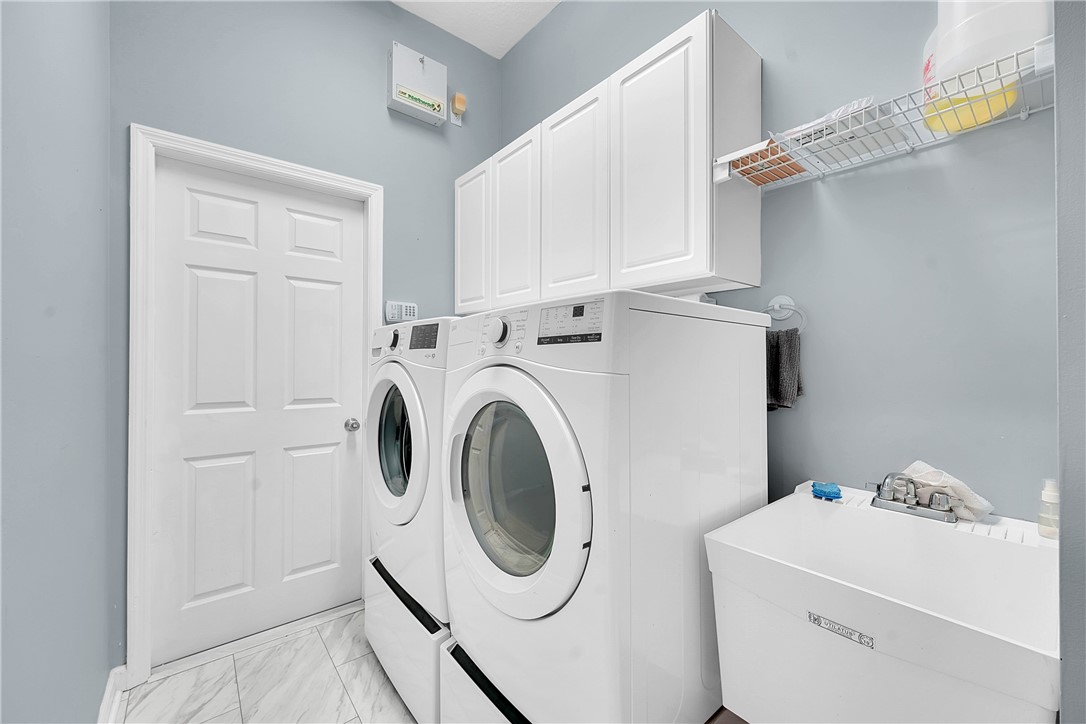 715 Southwest Munjack Circle Port St. Lucie, FL 34986 - Photo 24 of 36 a utility room with dryer and washer