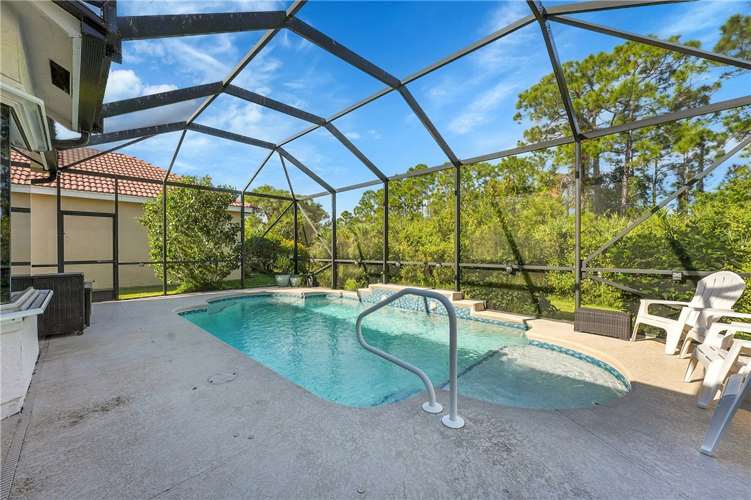 715 Southwest Munjack Circle Port St. Lucie, FL 34986 - Photo 27 of 36 a view of a swimming pool with a patio