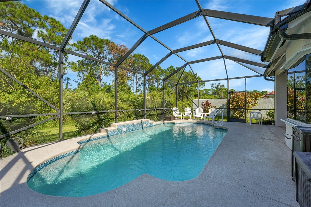 715 Southwest Munjack Circle Port St. Lucie, FL 34986 - Photo 28 of 36 a view of a swimming pool with a patio