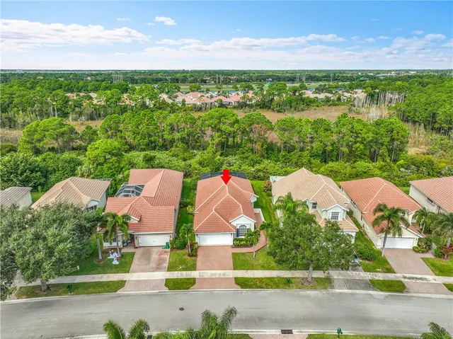 an aerial view of a house with a yard and swimming pool