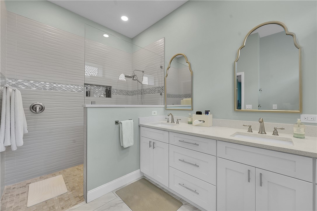 715 Southwest Munjack Circle Port St. Lucie, FL 34986 - Photo 5 of 36 a bathroom with a double vanity sink and mirror