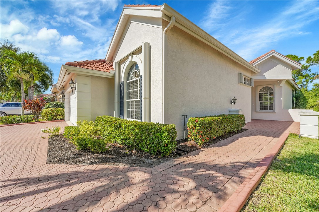 715 Southwest Munjack Circle Port St. Lucie, FL 34986 - Photo 8 of 36 a front view of a house with a yard