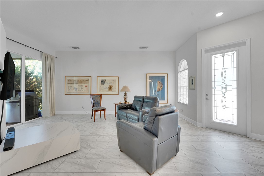 715 Southwest Munjack Circle Port St. Lucie, FL 34986 - Photo 10 of 36 a living room with furniture and a flat screen tv