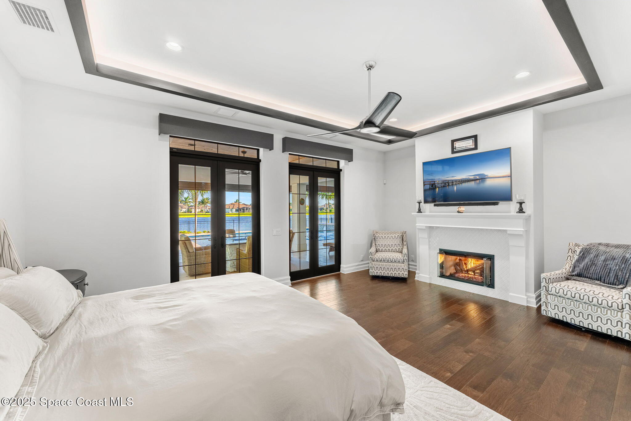 4655 Tea Tree Court Rockledge, FL 32955 - Photo 12 of 58 a living room with fireplace furniture and a flat screen tv