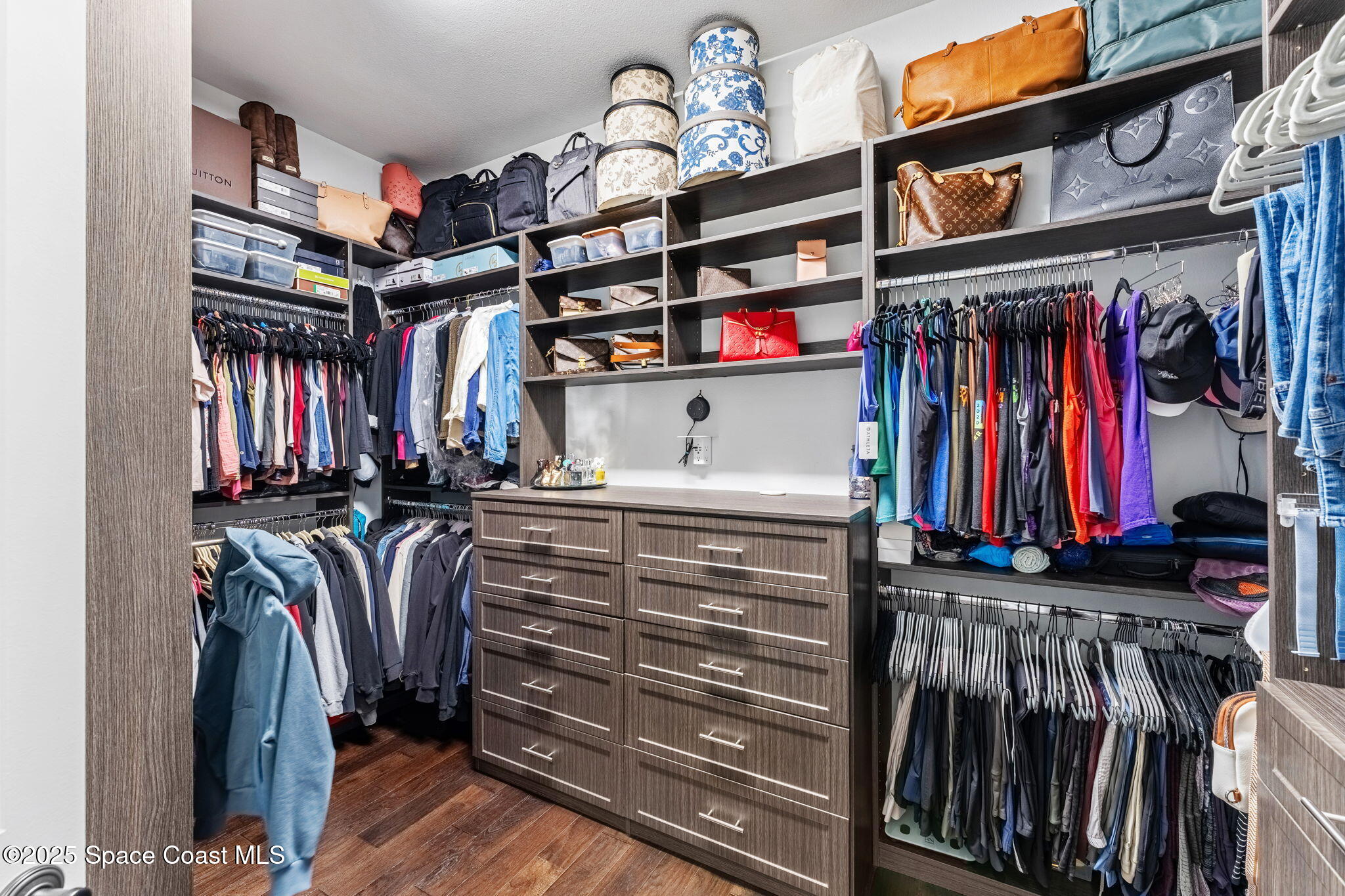 4655 Tea Tree Court Rockledge, FL 32955 - Photo 15 of 58 a view of walk in closet with clothes and shoes
