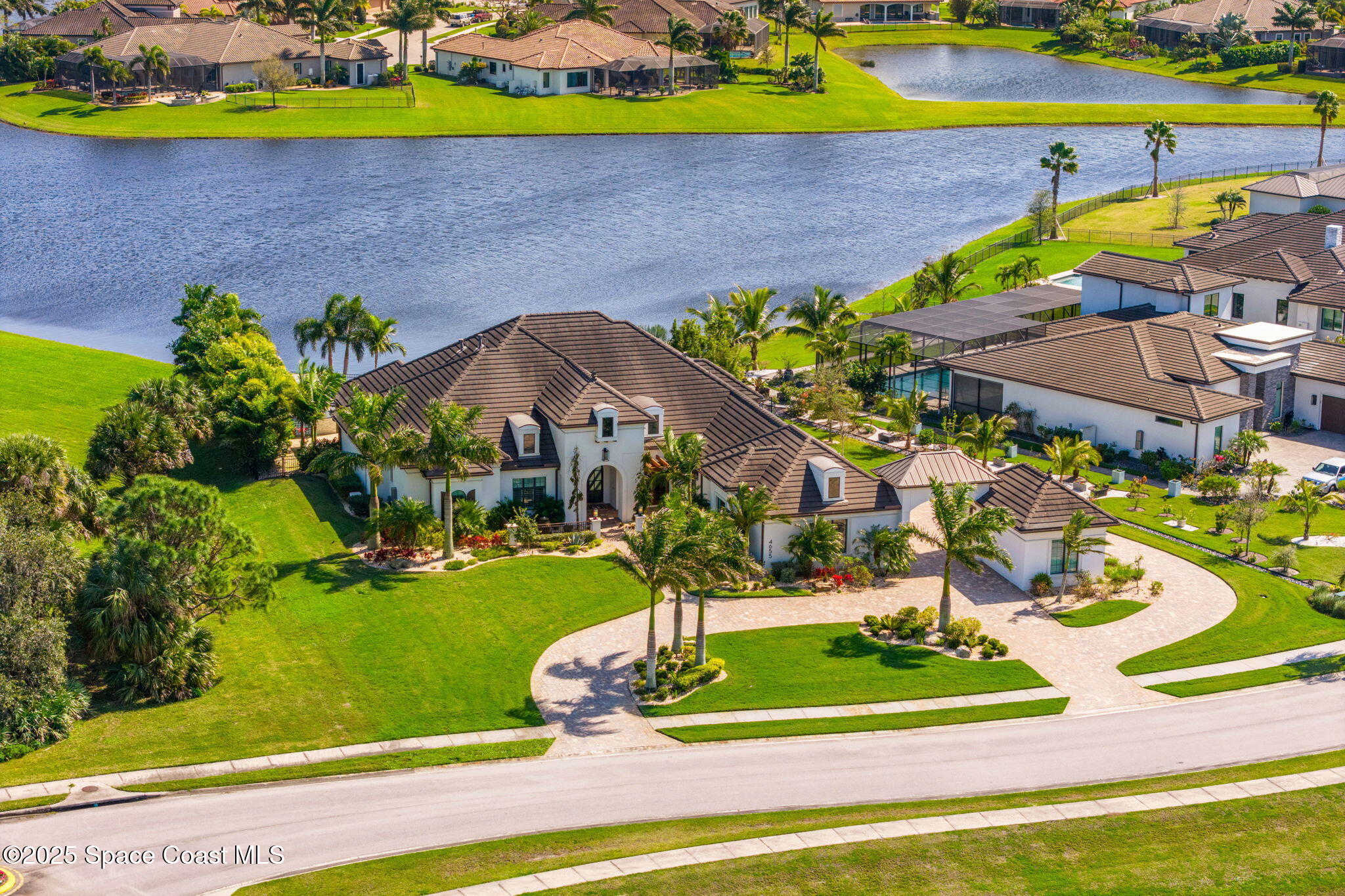 4655 Tea Tree Court Rockledge, FL 32955 - Photo 2 of 58 a view of a swimming pool with a patio and plants