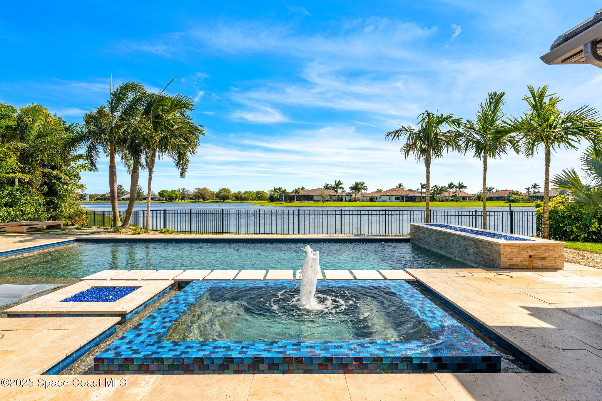 4655 Tea Tree Court Rockledge, FL 32955 - Photo 26 of 58 a view of swimming pool with seating space and palm tree