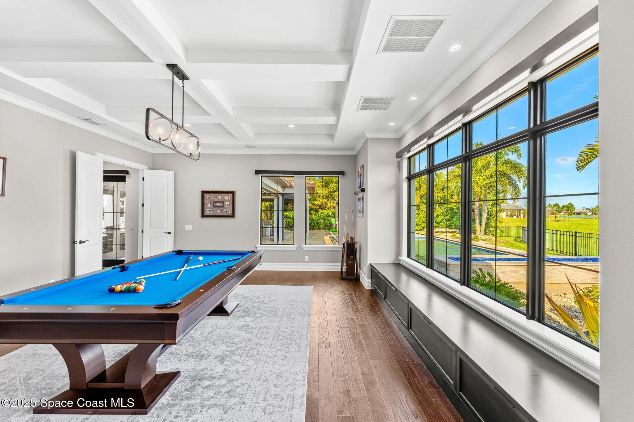 4655 Tea Tree Court Rockledge, FL 32955 - Photo 30 of 58 a room with pool table flat screen tv and windows