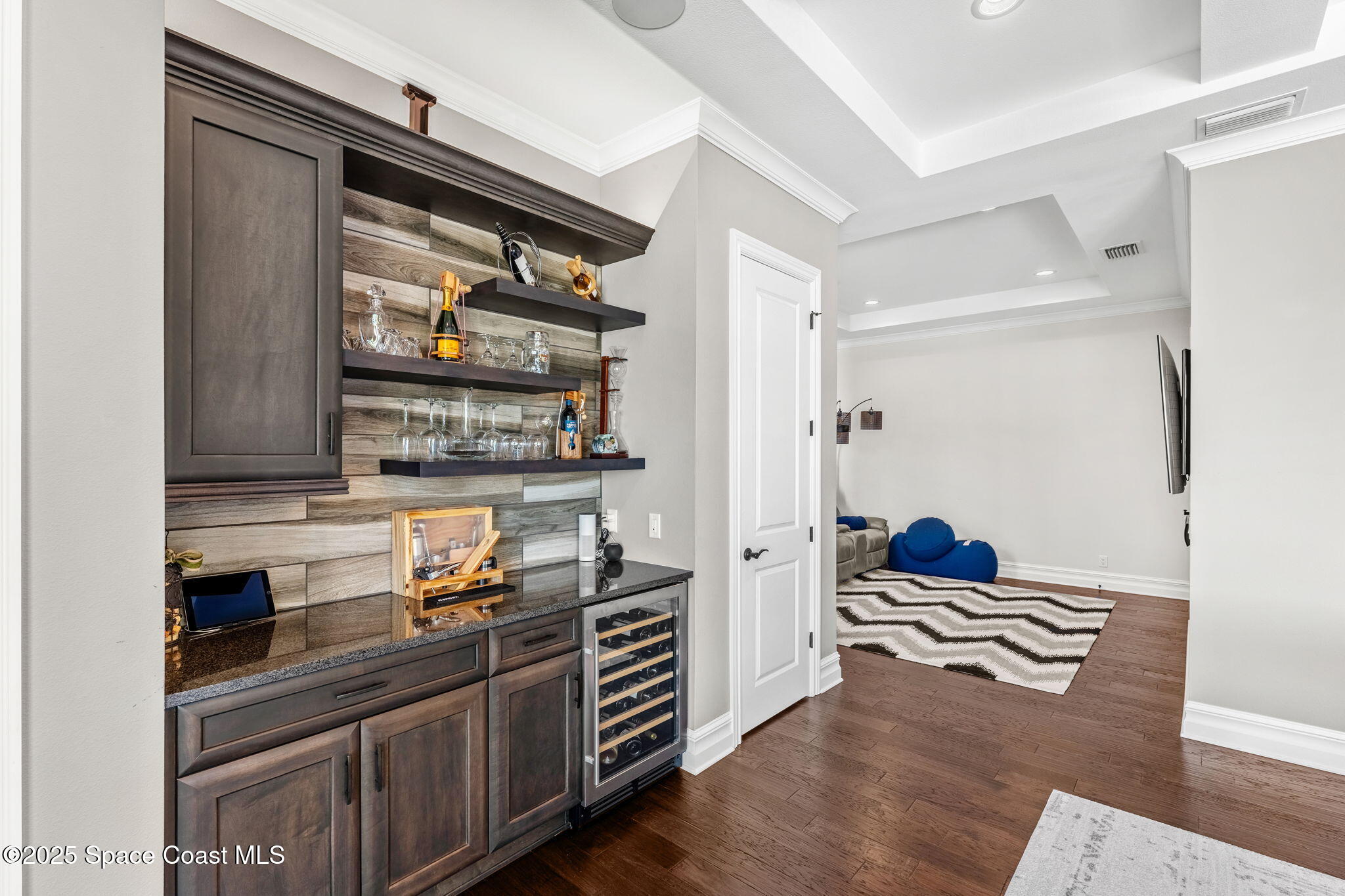 4655 Tea Tree Court Rockledge, FL 32955 - Photo 32 of 58 a kitchen with stainless steel appliances and wooden floor