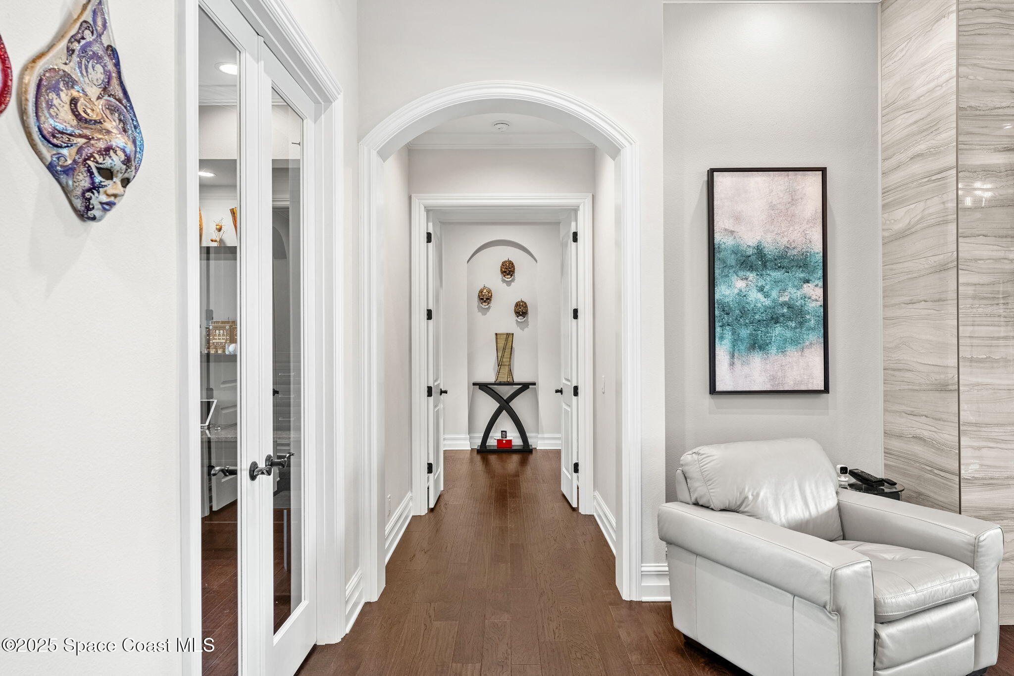 4655 Tea Tree Court Rockledge, FL 32955 - Photo 34 of 58 a view of a hallway with couches and a large mirror with a window