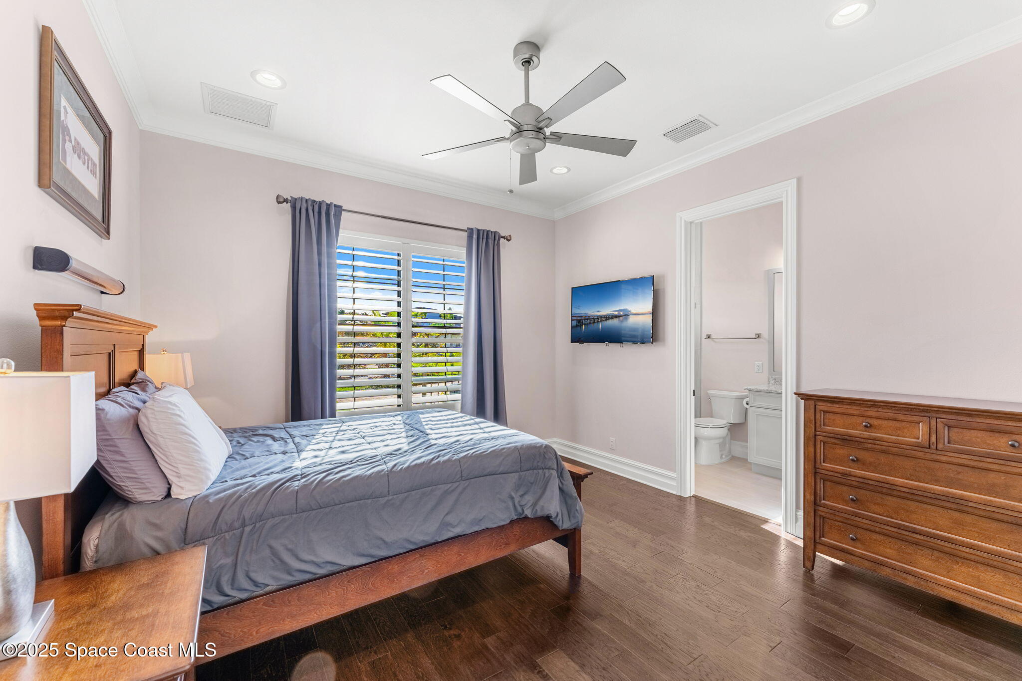 4655 Tea Tree Court Rockledge, FL 32955 - Photo 38 of 58 a bedroom with a bed and a ceiling fan