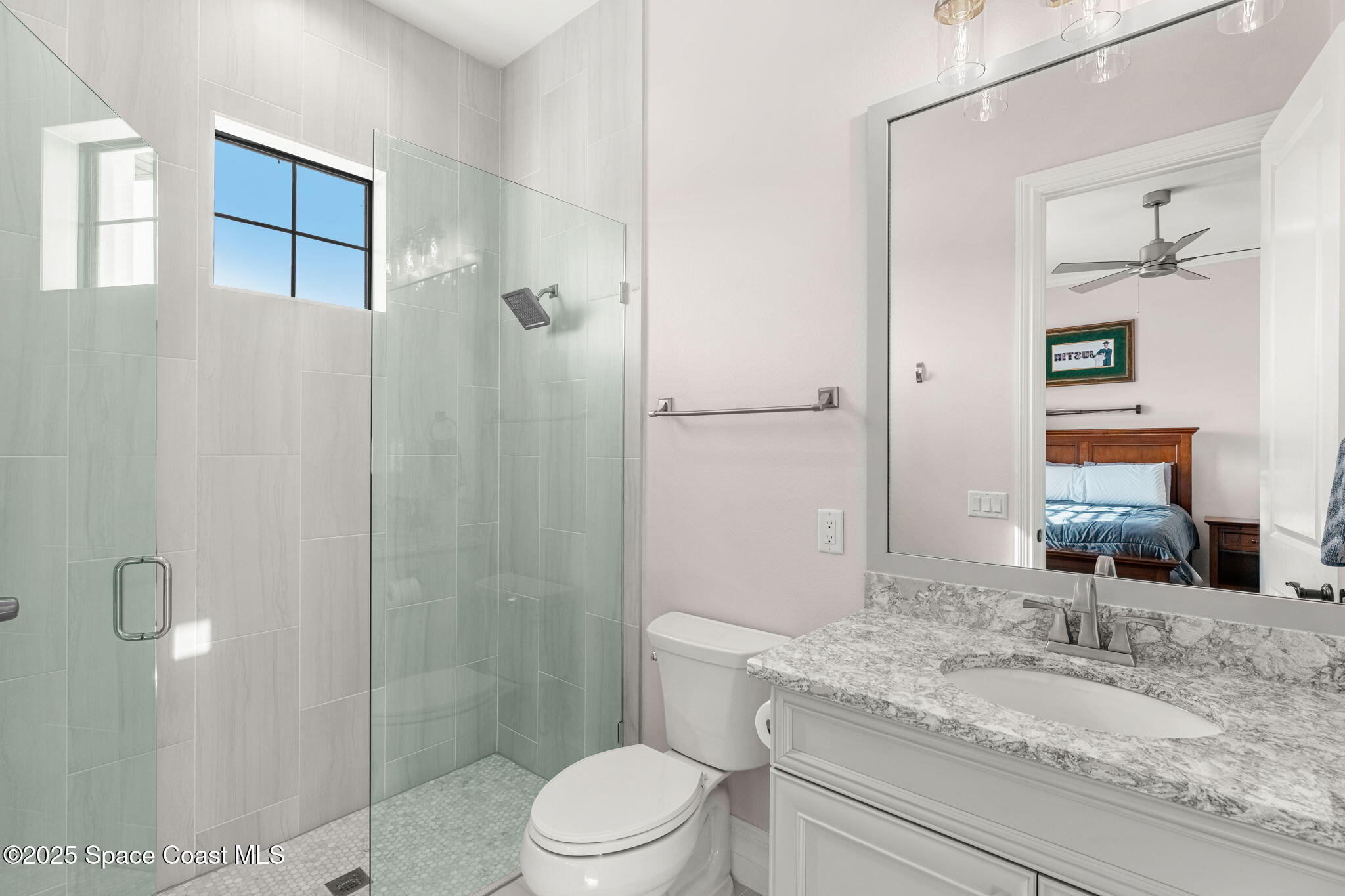 4655 Tea Tree Court Rockledge, FL 32955 - Photo 40 of 58 a bathroom with a granite countertop sink toilet and shower