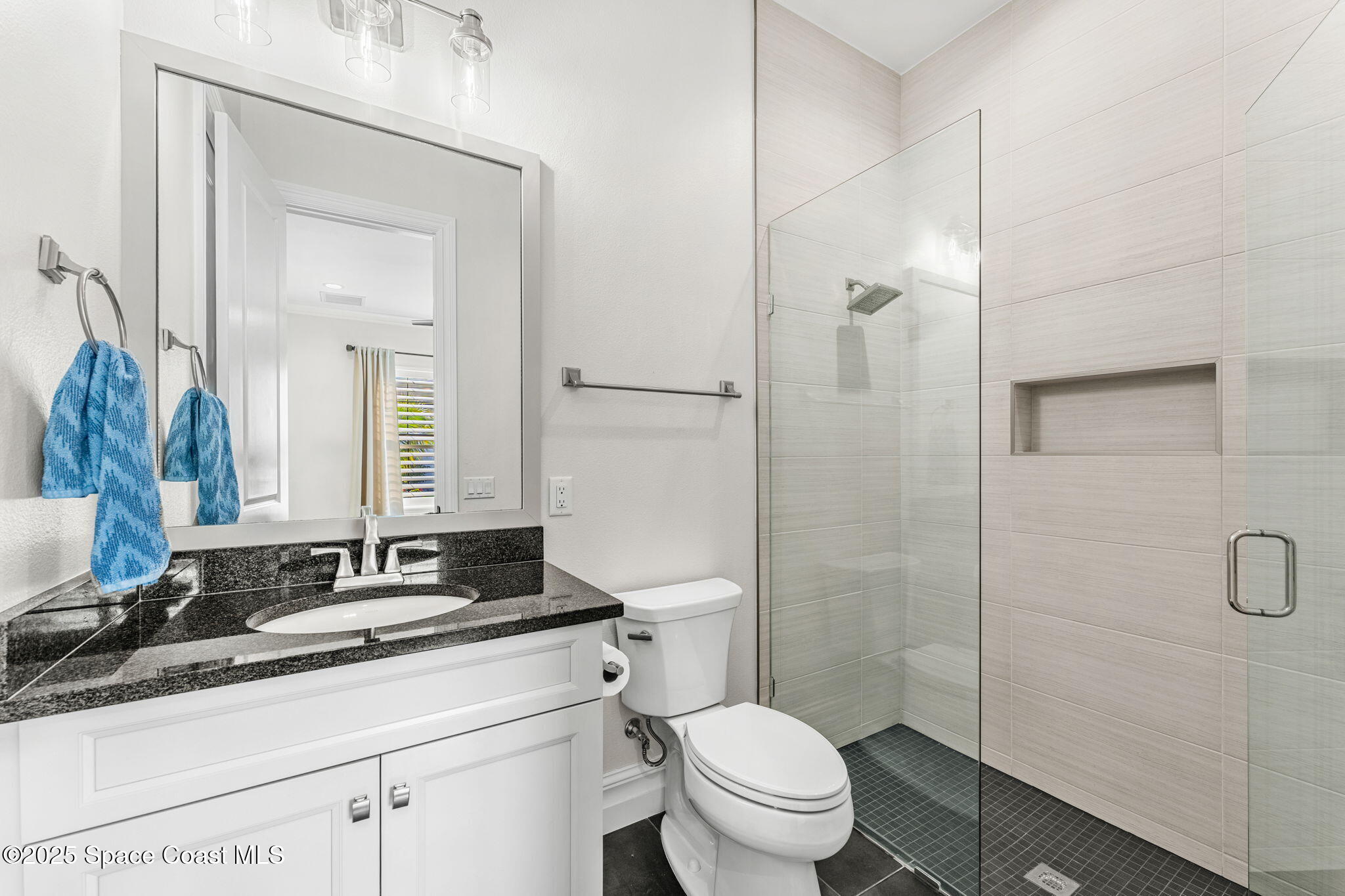 4655 Tea Tree Court Rockledge, FL 32955 - Photo 41 of 58 a bathroom with a granite countertop sink toilet and shower