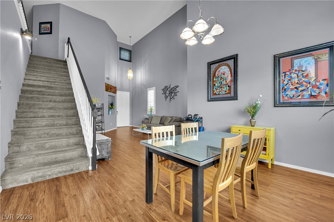 1724 Millstream Way Henderson, NV 89074 - Photo 59 of 60 An open floorplan with soaring ceilings and richly toned hardwood flooring defines this versatile living and dining space.