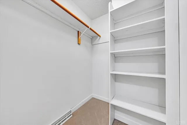 a view of a livingroom with wooden floor and a chandelier