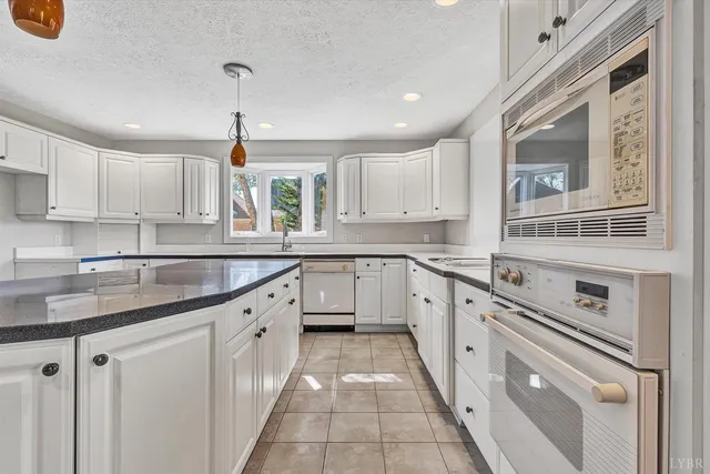 a view of staircase with wooden floor and white walls