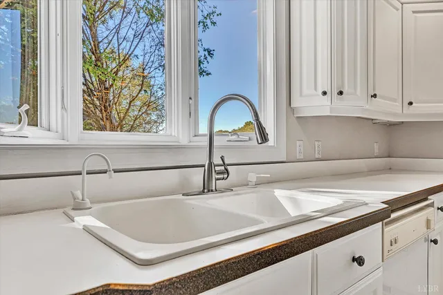 a view of a hallway with a chandelier fan