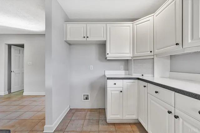an empty room with a window and a ceiling fan