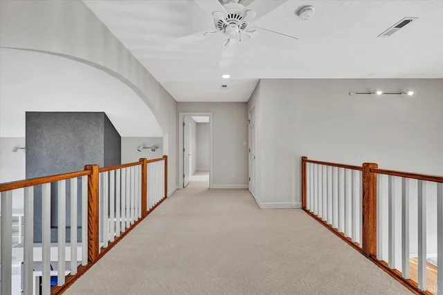 a view of a balcony with wooden floor and wooden fence
