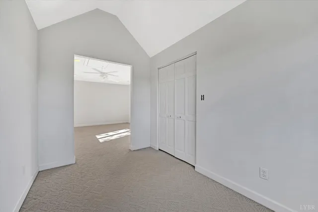 a view of a lake with a bench and trees