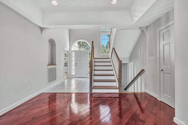 a view of a livingroom with wooden floor and a fireplace