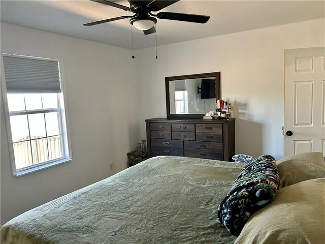 a bedroom with a bed and a dresser
