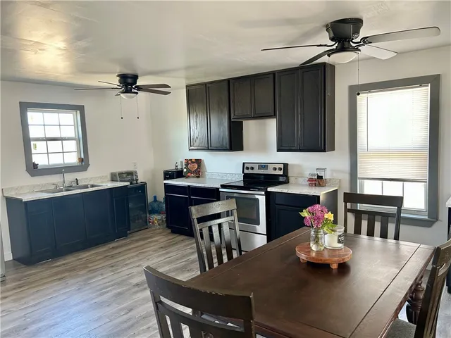 a kitchen with a dining table cabinets and appliances