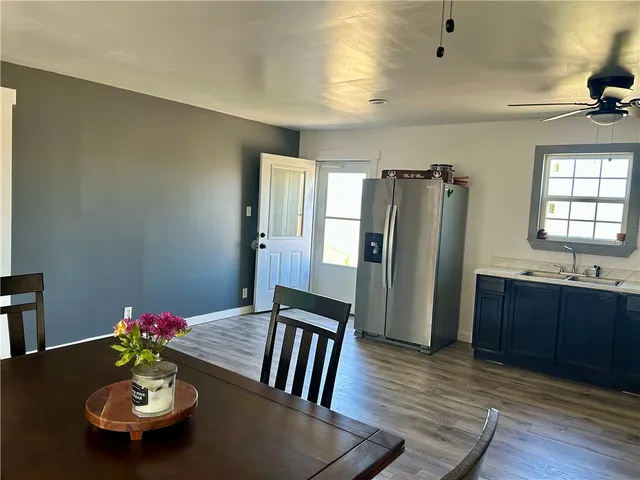 a kitchen with sink refrigerator and window