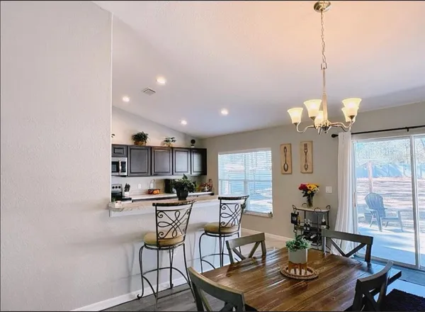 a view of a dining room with furniture window and outside view