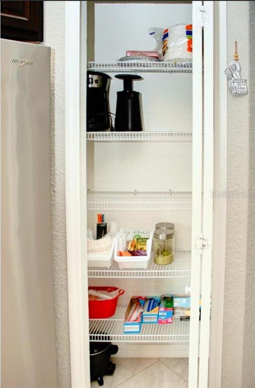 12365 Indigo Bunting Road Weeki Wachee, FL 34614 - Photo 17 of 39 a utility room with an empty shelf