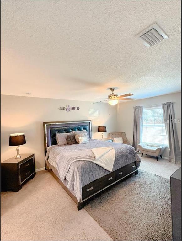 12365 Indigo Bunting Road Weeki Wachee, FL 34614 - Photo 18 of 39 a bedroom with a bed and a couch