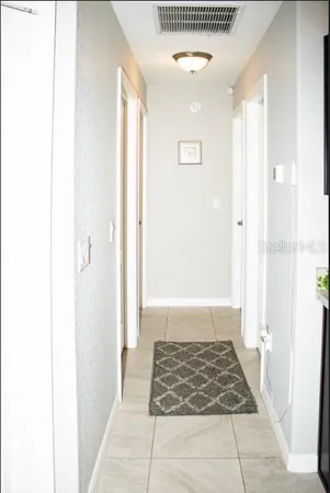 a bedroom with a bed and a flat tv screen on dresser
