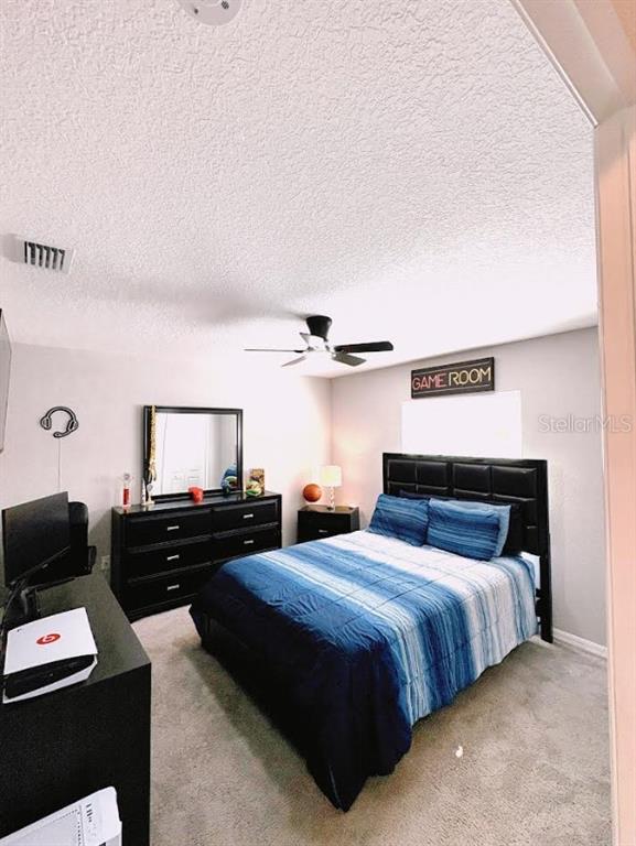 12365 Indigo Bunting Road Weeki Wachee, FL 34614 - Photo 29 of 39 a bedroom with two beds and a computer on a desk next to a window