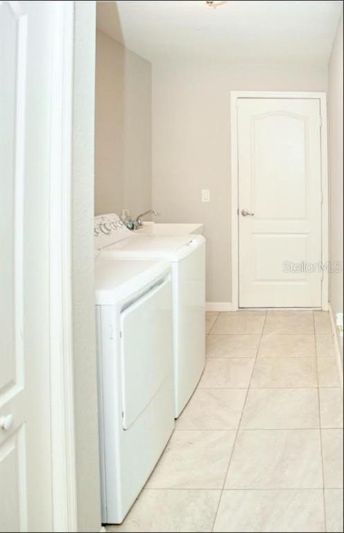 12365 Indigo Bunting Road Weeki Wachee, FL 34614 - Photo 32 of 39 a utility room with dryer and washer