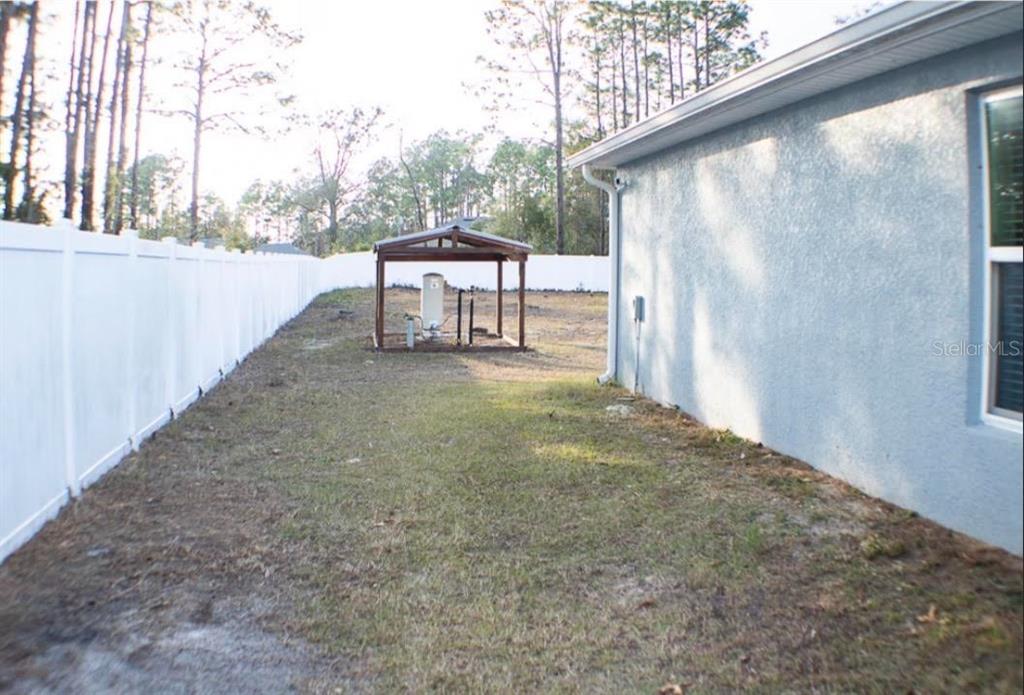 12365 Indigo Bunting Road Weeki Wachee, FL 34614 - Photo 37 of 39 a view of a bench in the backyard of a house