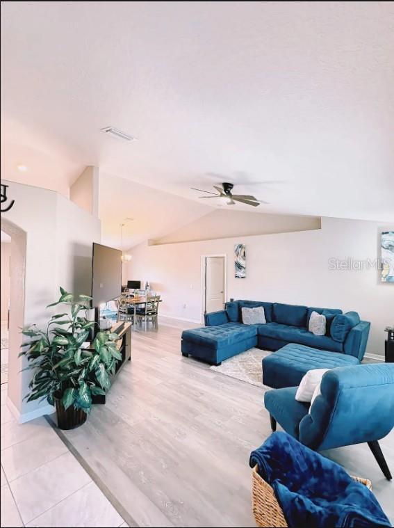 12365 Indigo Bunting Road Weeki Wachee, FL 34614 - Photo 7 of 39 a living room with furniture and a chandelier