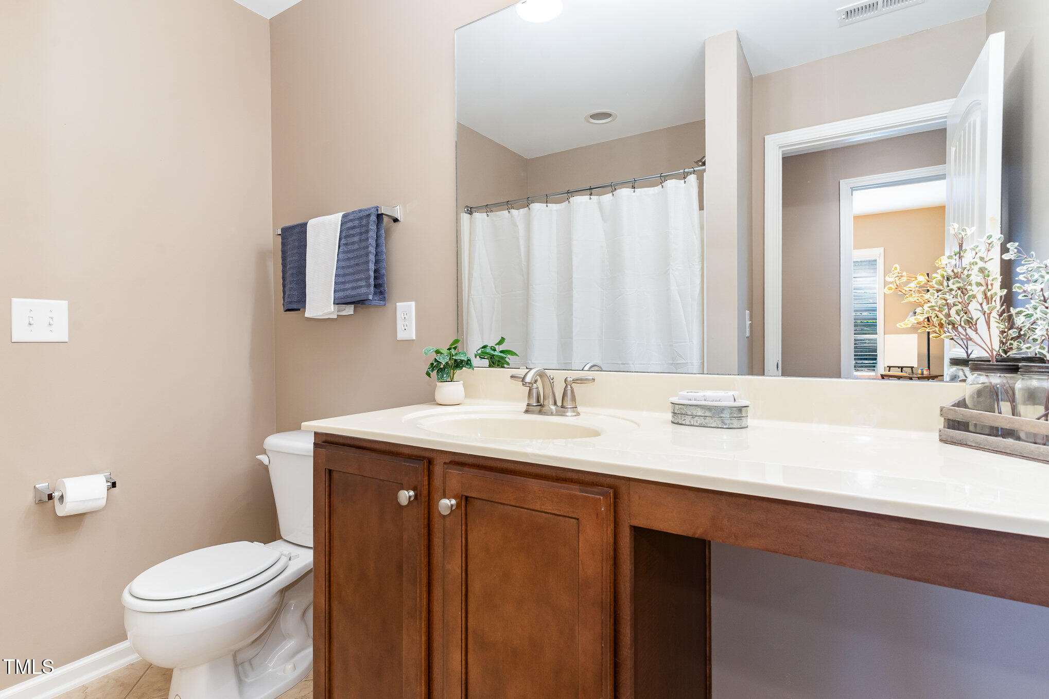 4732 Altha Street Raleigh, NC 27606 - Photo 14 of 23 a bathroom with a sink and a mirror with toilet