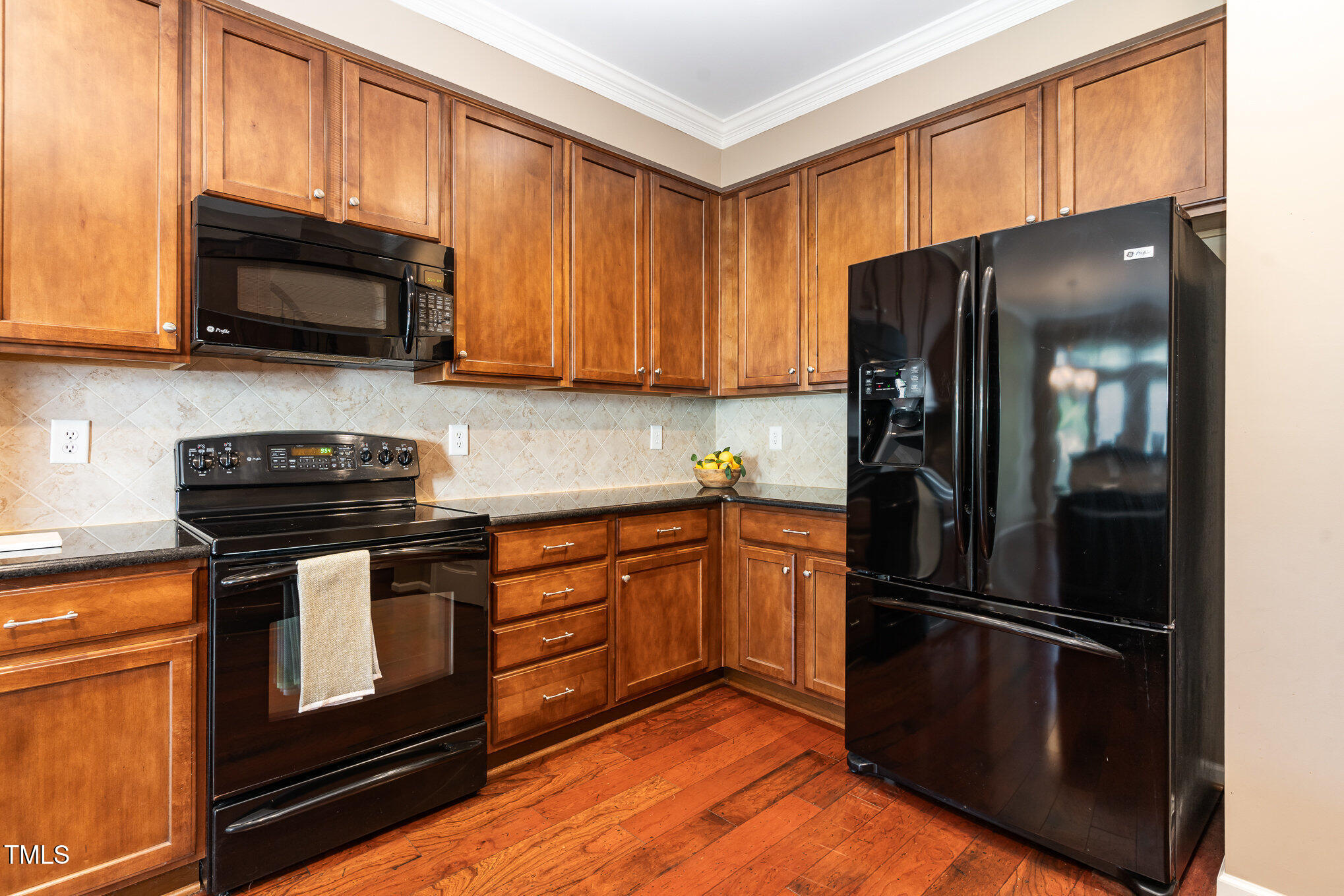 4732 Altha Street Raleigh, NC 27606 - Photo 7 of 23 a kitchen with stainless steel appliances granite countertop a refrigerator stove and microwave