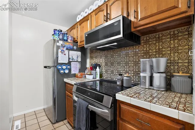 a kitchen with stainless steel appliances granite countertop a sink and cabinets