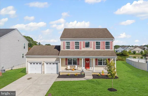 a front view of house with yard and outdoor seating