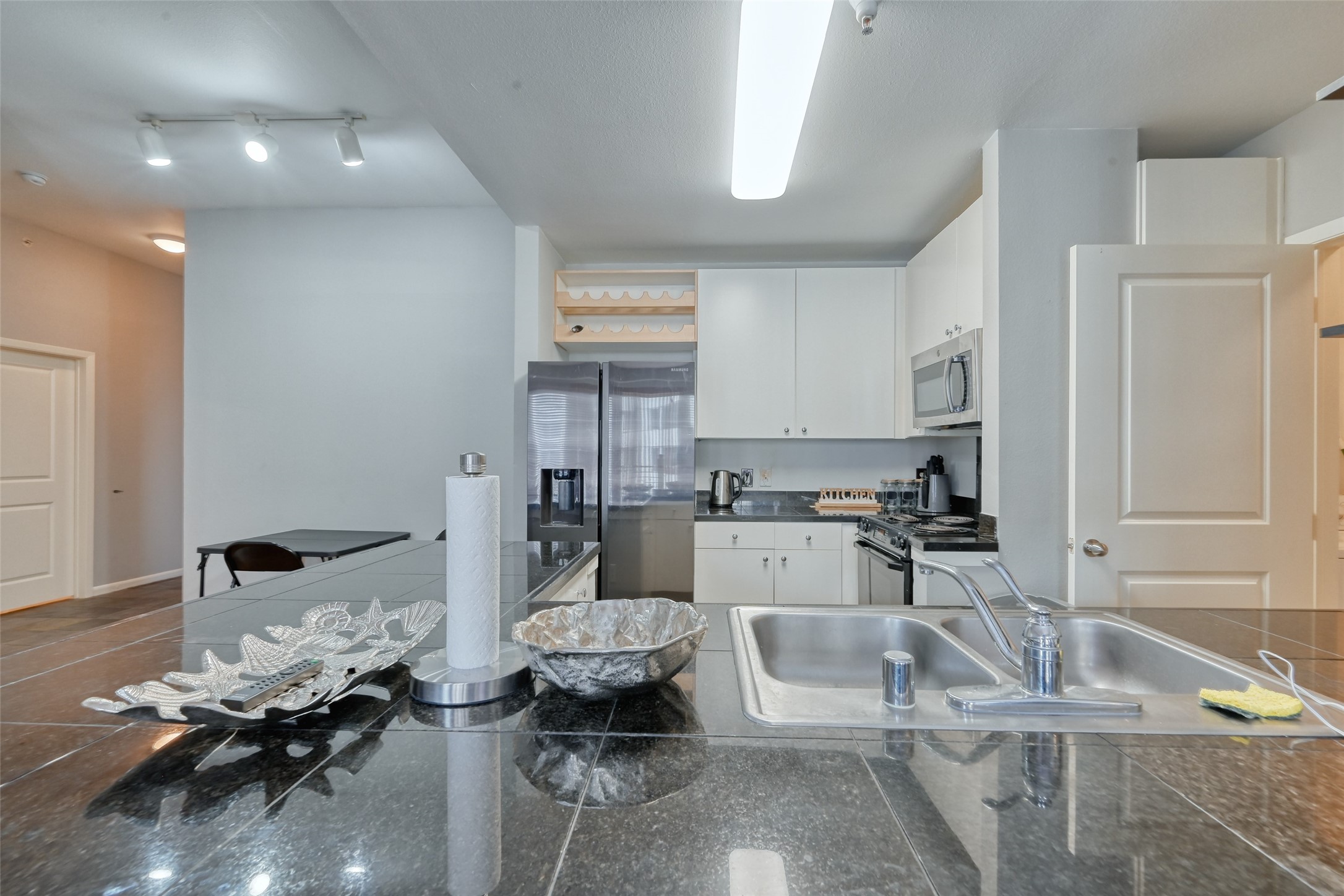 3505 Sage Road, Unit 1206 Houston, TX 77056 - Photo 25 of 50 a kitchen with white cabinets and sink