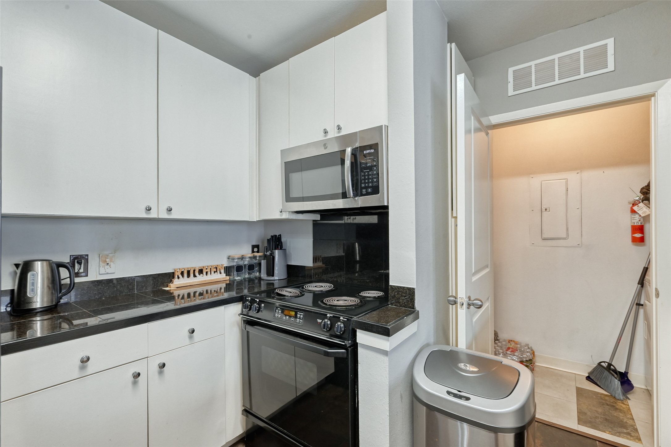 3505 Sage Road, Unit 1206 Houston, TX 77056 - Photo 30 of 50 a kitchen with granite countertop a sink stove and cabinets