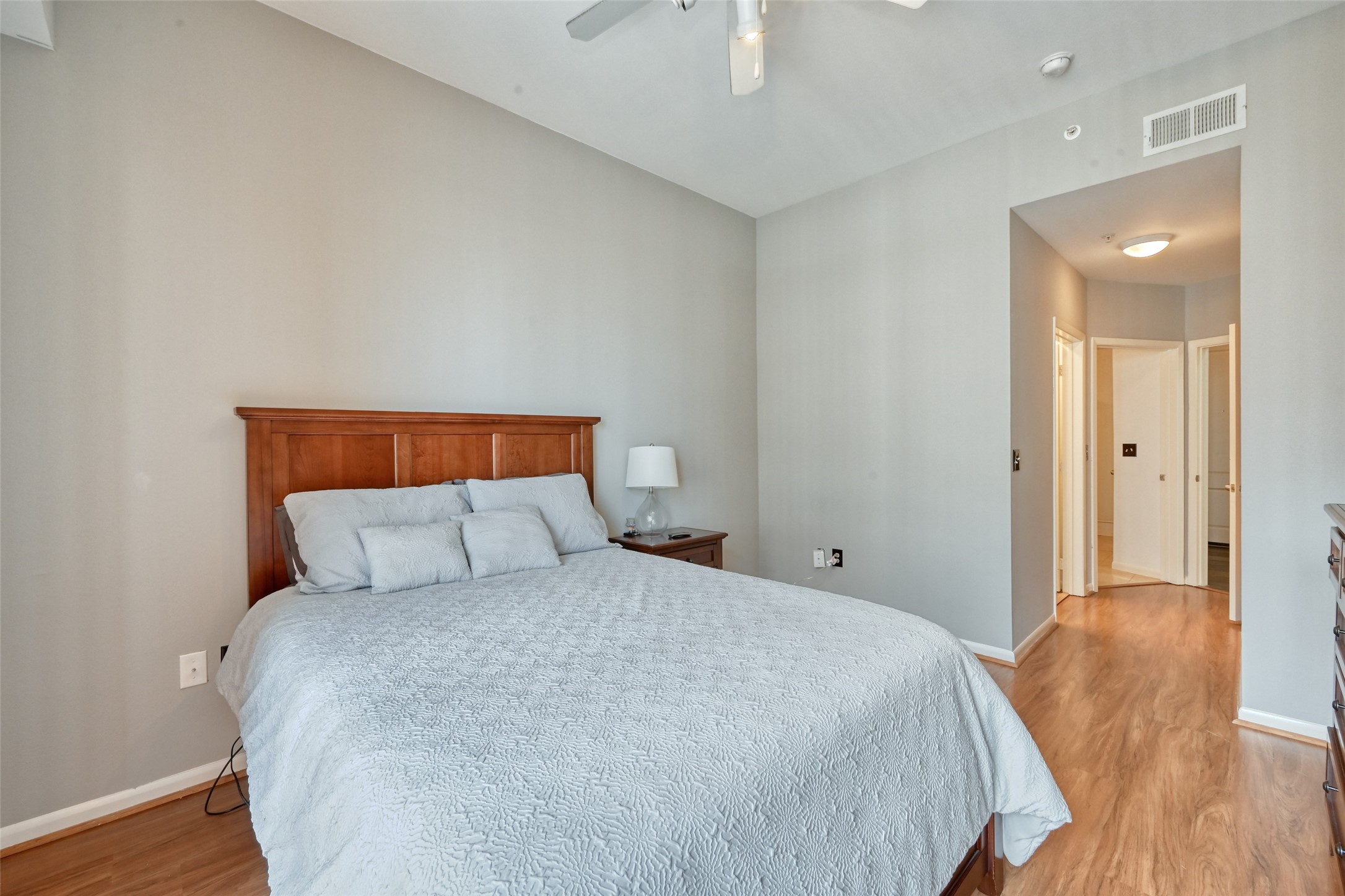 3505 Sage Road, Unit 1206 Houston, TX 77056 - Photo 37 of 50 a bedroom with a bed and wooden floor