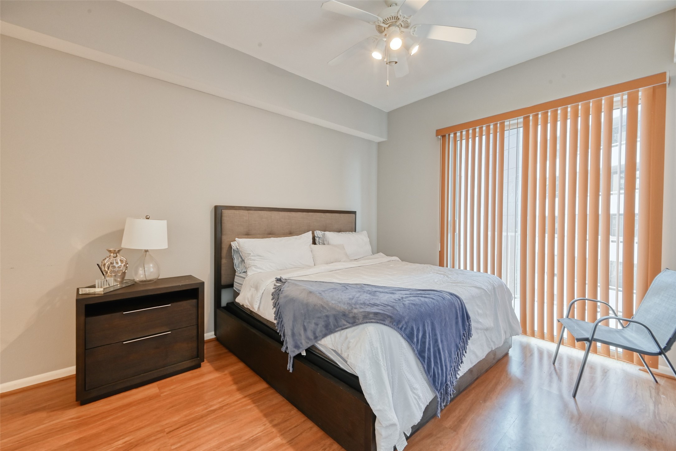 3505 Sage Road, Unit 1206 Houston, TX 77056 - Photo 39 of 50 a bedroom with a bed and wooden floor